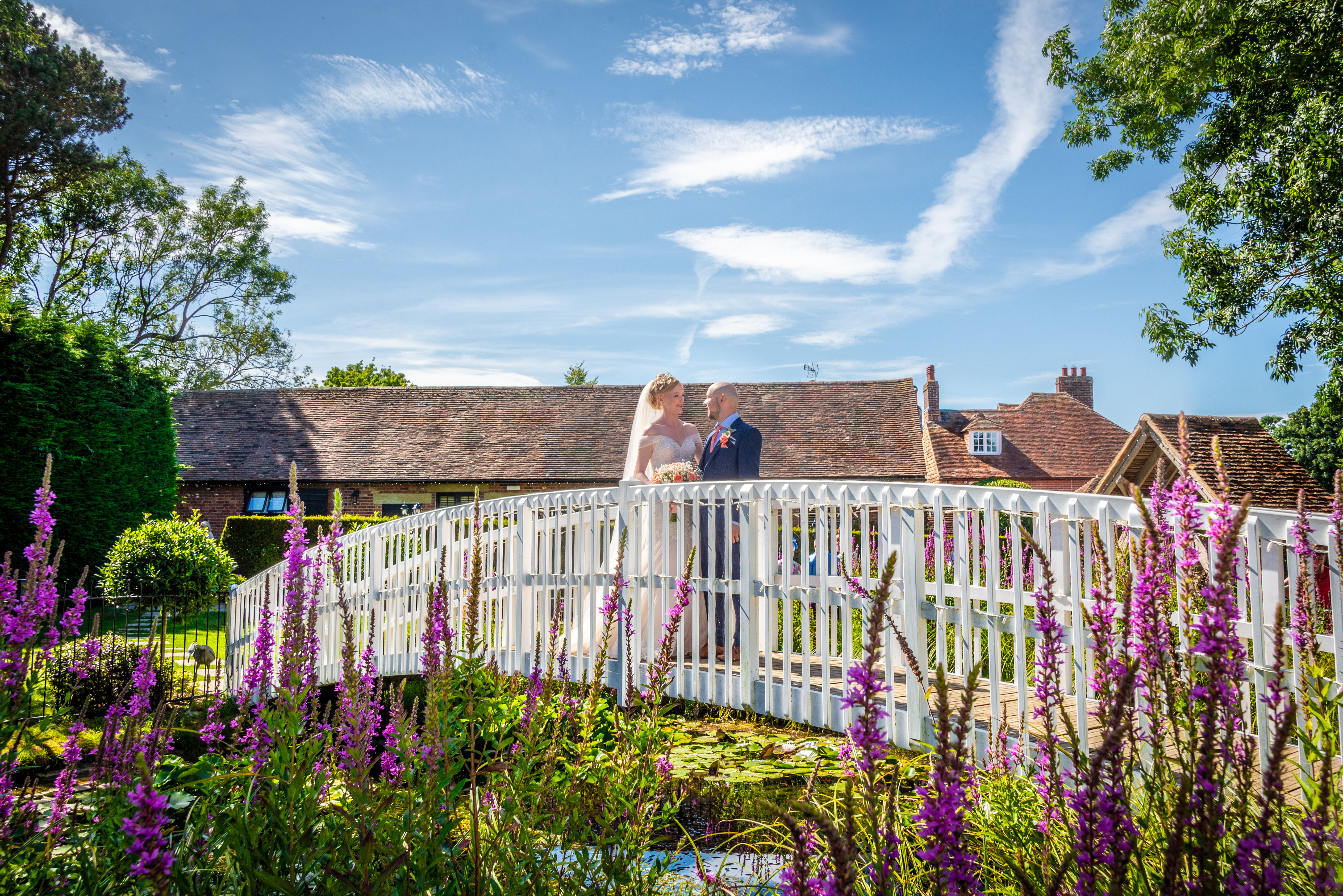 Couples photo on the bridge at Winters Barn Wedding Venue in Ashford