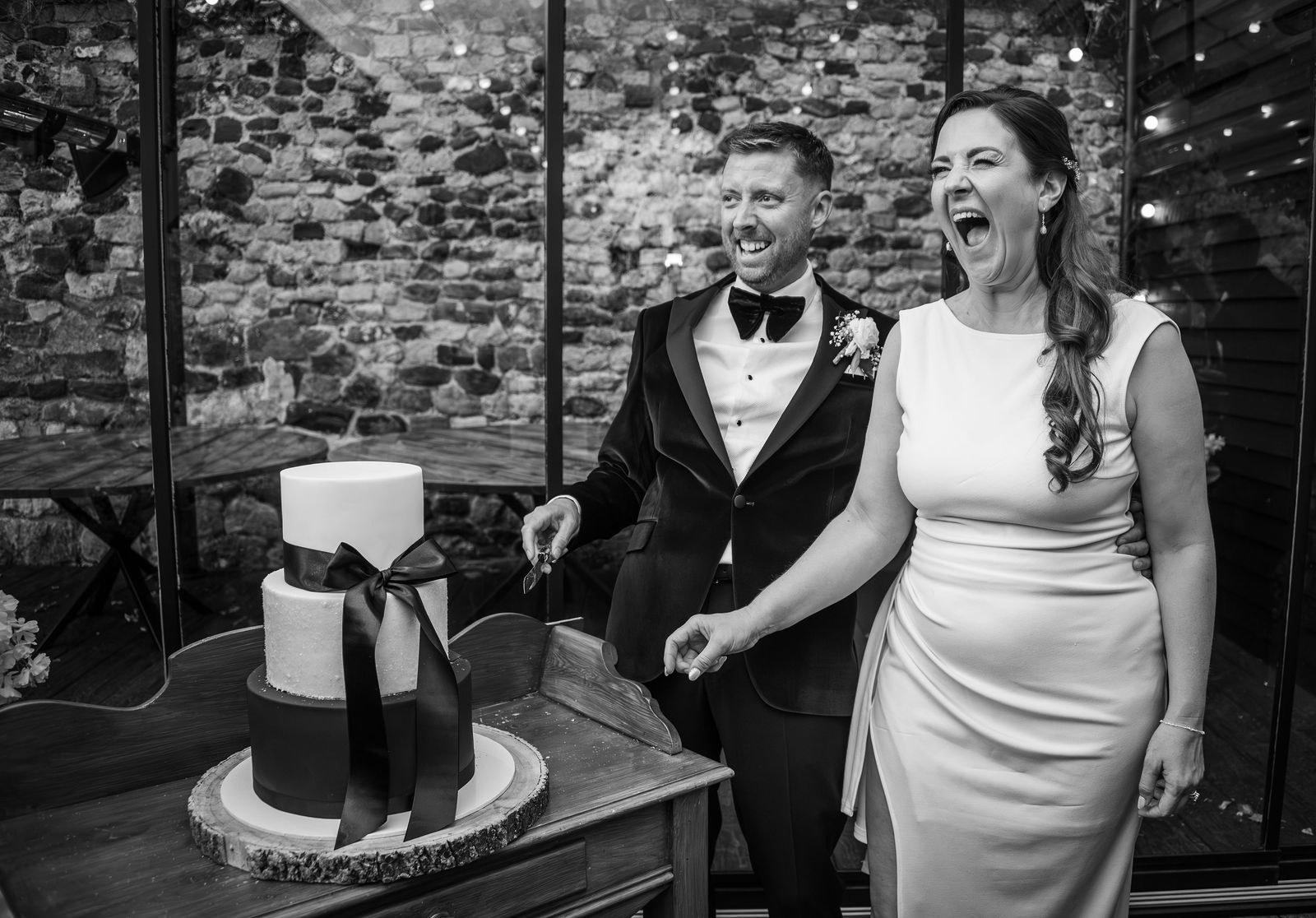 Cutting the cake at the Buttery and Glasshouse wedding venue in Kent