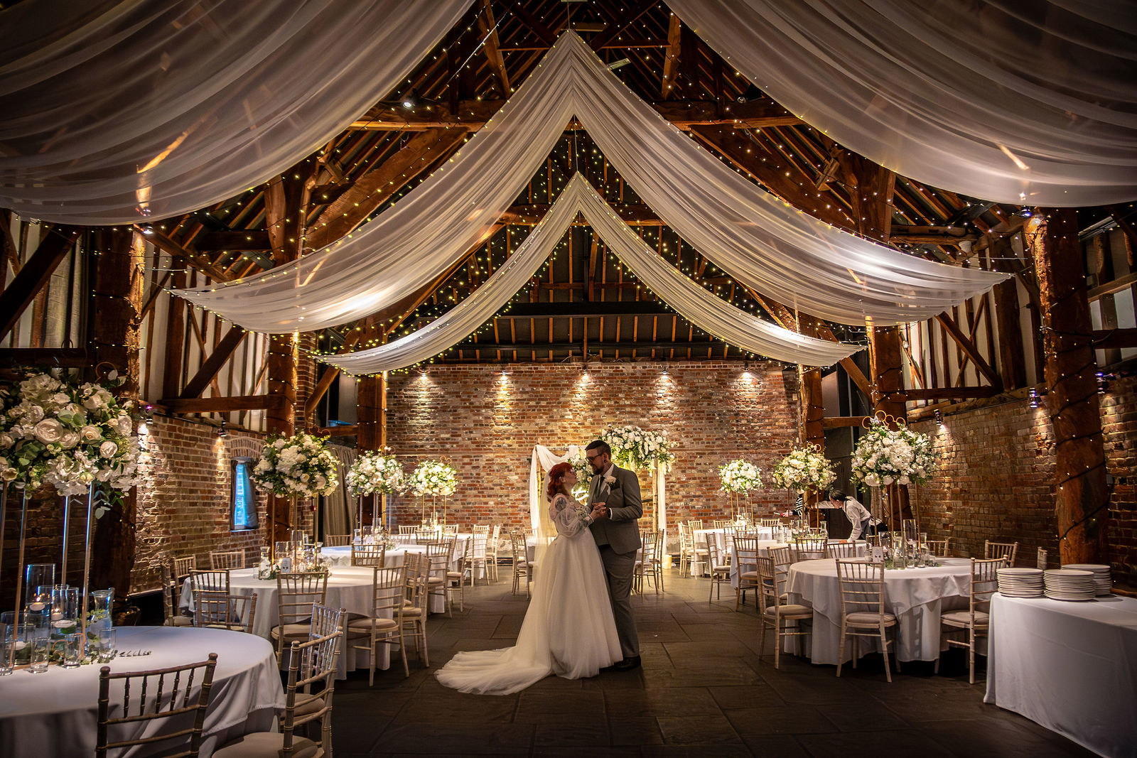 Couples portrait in the barn at Cooling Castle Barn Wedding Venue in Rochester