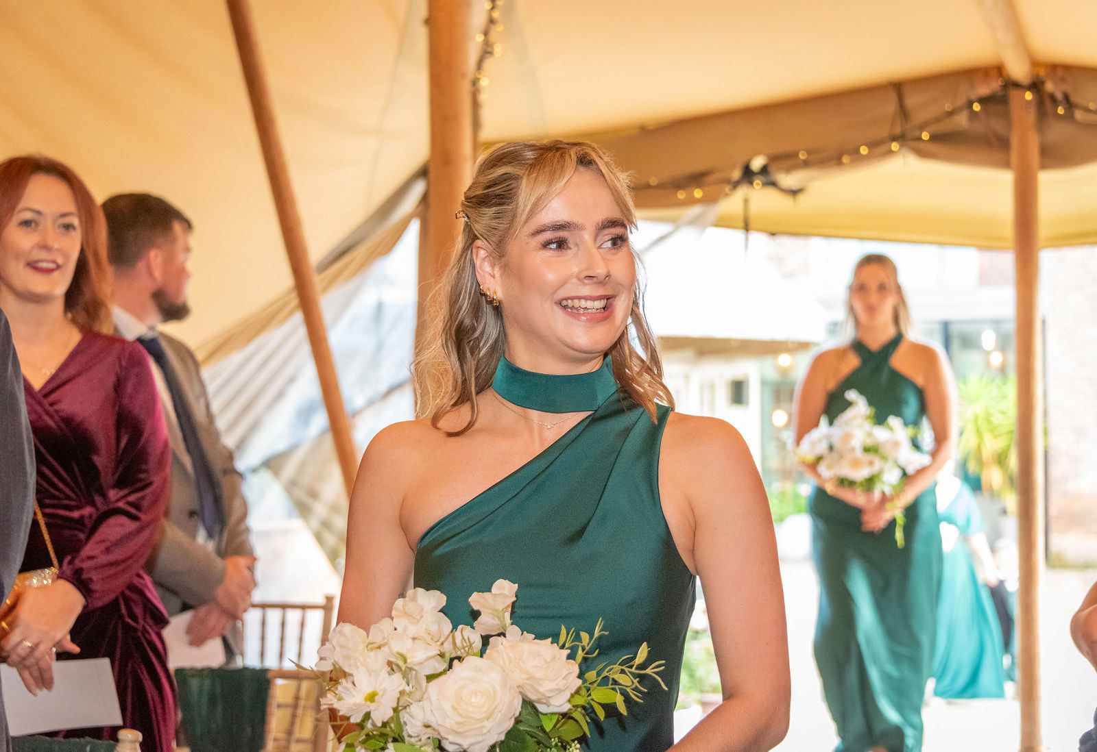 Bridesmaids proceed down the aisle at The Vines of Rochester wedding venue in Kent