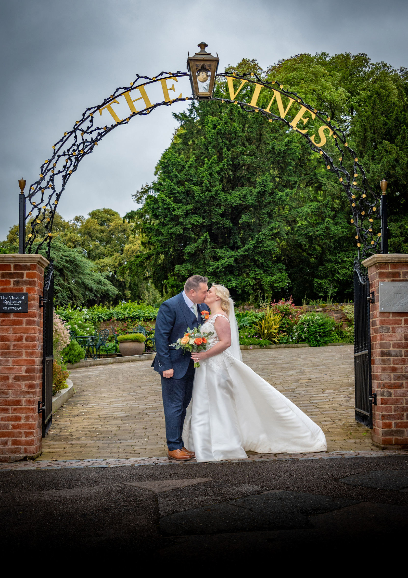 Couples portrait under the arch at The Vines of Rochester wedding venue in Kent